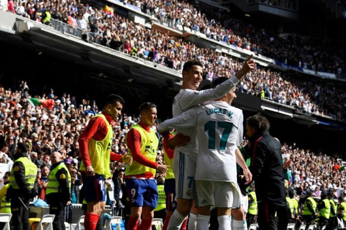 Megabintang Real Madrid, Cristiano Ronaldo (tengah), merayakan golnya ke gawang Atletico Madrid dalam laga Liga Spanyol di Stadion Santiago Bernabeu, Madrid pada 8 April 2018.