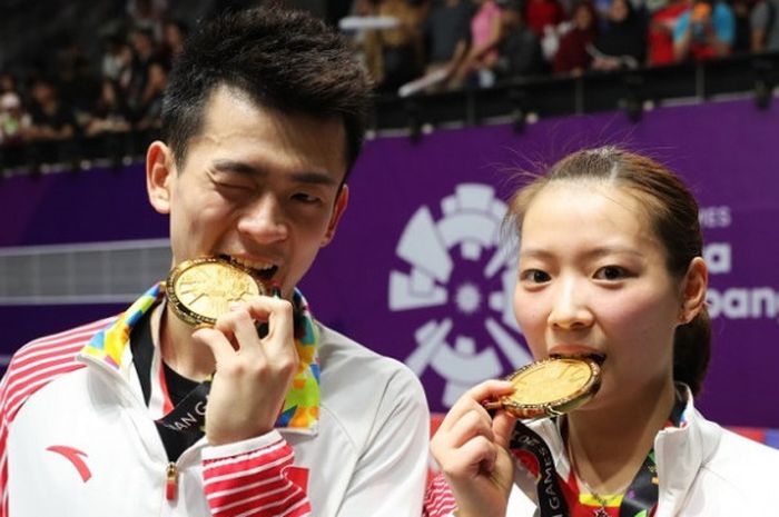 Pasangan ganda campuran China, Zheng Siwei/Huang Yaqiong, berpose setelah memastikan medali emas pada Asian Games 2018.