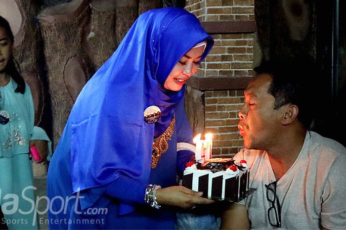 Aji Santoso meniup lilin kue ulang tahun yang disodorkan oleh istrinya, Rini Sofia, saat makan malam bersama wartawan dalam perayaan ulang tahun Aji yang ke-47 di sebuah rumah makan di sekitar Stadion Gajayana, Kota Malang, Senin (10/4/2017) malam.