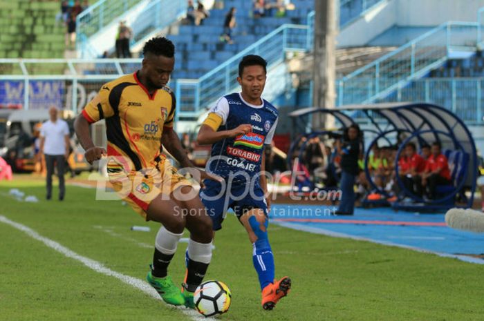 Kapten Arema FC, Dendi Santoso, berebut bola dengan bek Mitra Kukar, Mauricio Leal, dalam duel pekan pertama Liga 1 2018 di Stadion Kanjuruhan, Malang, Sabtu (24/3/2018)