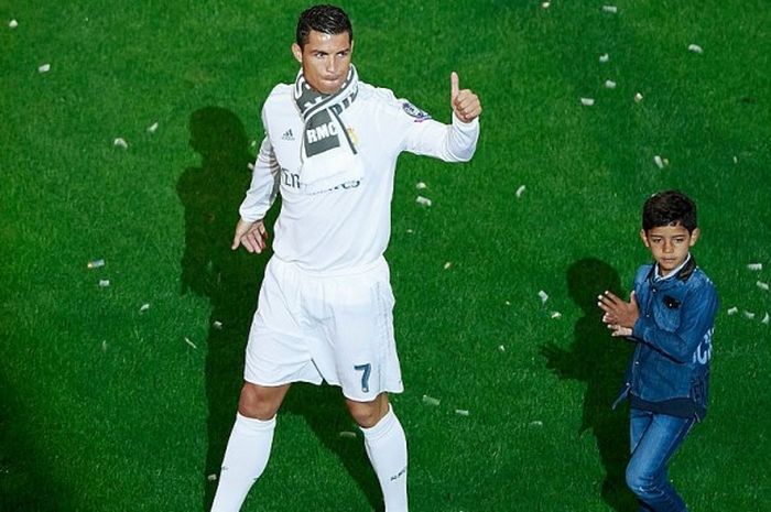 Cristiano Ronaldo (kiri) bersama anaknya, Cristiano Ronaldo Jr, saat merayakan keberhasilan Real Madrid menjuarai Liga Champions 2015-2016 di hadapan fans di Stadion Santiago Bernabeu, Madrid, Spanyol, pada 29 Mei 2016.