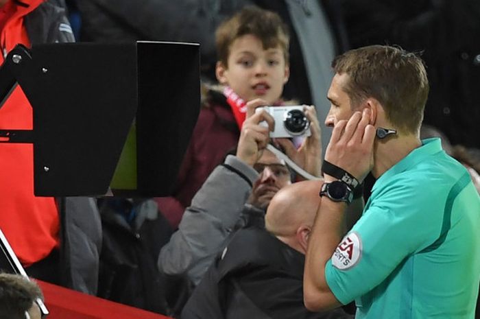 Wasit Craig Pawson melihat layar bantu setelah berbicara dengan VAR (Video Assistant Referee) dalam laga babak IV Piala FA antara Liverpool dan West Bromwich Albion di Anfield, 27 Januari 2018.