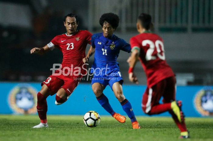   Bek timnas U-23 Indonesia,, Hansamu Yama Pranata, mengawal pemain timnas U-23 Thailand, Tanasith S