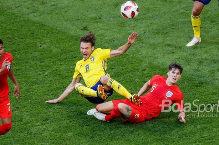  Bek Inggris, John Stones (5), melakukan tekel terhadap pemain Swedia, Albin Ekdal, dalam partai perempat final Piala Dunia 2018 di Samara Arena, 7 Juli 2018. 