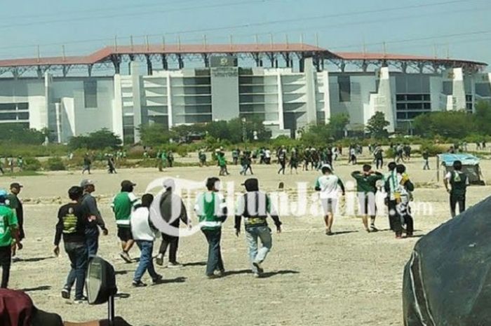 Kondisi tambak di sekitar Stadion Gelora Bung Tomo yang kering dan dilewati oleh Bonek.