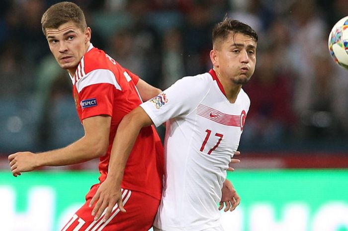 Gelandang timnas Rusia, Roman Zobnin (kiri), berduel dengan penyerang timnas Turki, Cengiz Under, dalam pertandingan Liga B Grup 2 UEFA Nations League di Stadion Olimpiade Fisht, Sochi, Rusia, pada Minggu (14/10/2018).