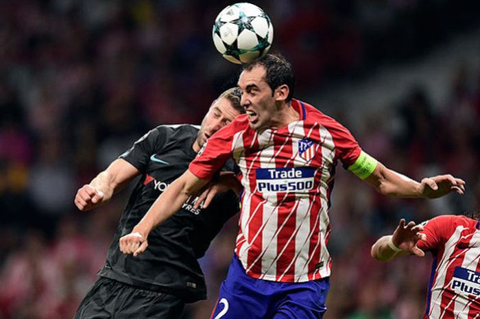 Bek Atletico Madrid, Diego Godin (kanan), berebut bola dengan bek Chelsea, Gary Cahill, dalam laga lanjutan Grup C Liga Champions 2017-2018 di Stadion Metropolitan, Madrid, pada 27 September 2017.