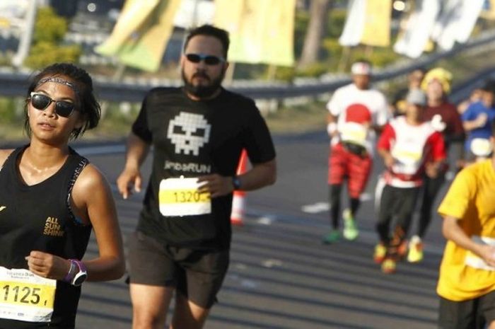 Para pelari nomor full-marathon beraksi menyusuri rute Maybank Bali Marathon 2016, Minggu (28/8/2016).