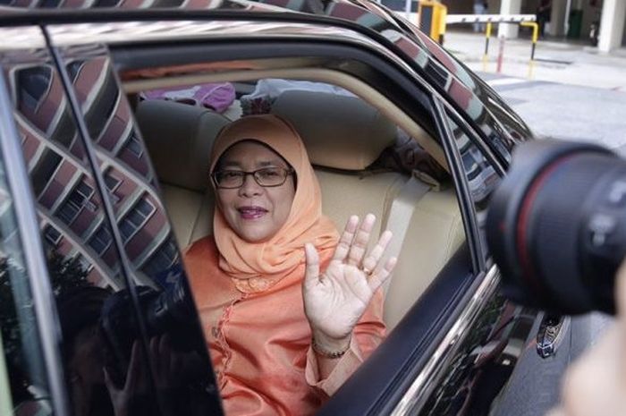 Halimah Yacob melambaikan tangan dari dalam mobil ketika meninggalkan tempat tinggal flatnya, Yishun, menuju NTUC Centre, Singapura, Rabu (13/9/2017).