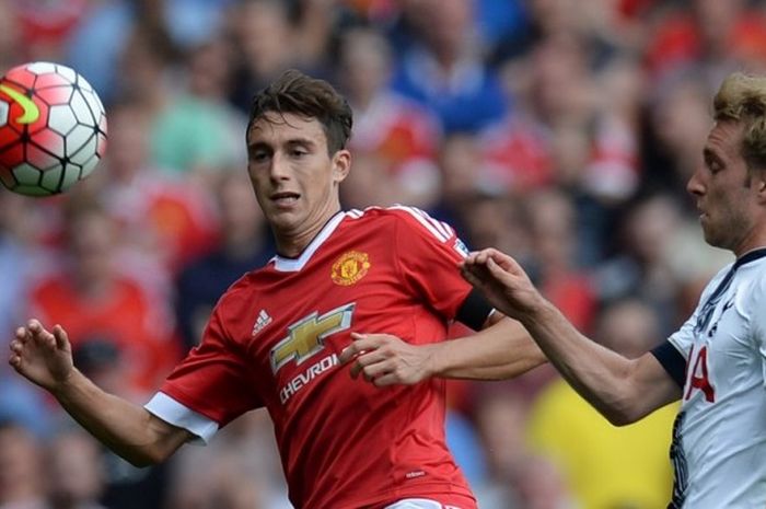   Pemain belakang Manchester United, Matteo Darmian (kiri), berduel dengan gelandang Tottenham Hotspur, Christian Eriksen, pada partai Premier Leagu di Stadion Old Trafford, 8 Agustus 2015.  