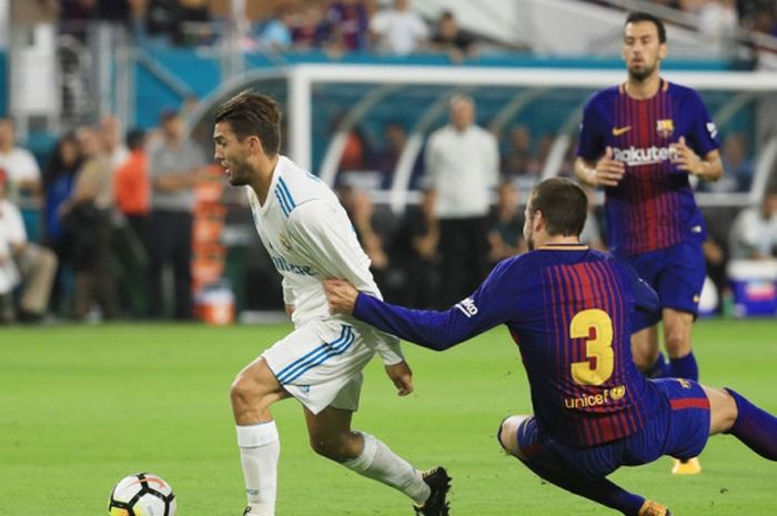 Gelandang Real Madrid, Mateo Kovacic (kiri), menggocek bek FC Barcelona, Gerard Pique, dalam laga International Champions Cup di Stadion Hard Rock, Florida, Amerika Serikat, pada 29 Juli 2017.