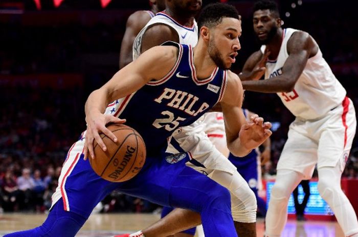 Rookie Philadelphia 76ers, Ben Simmons (jersey biru, #25), berupaya melewati penjagaan pemain LA Clippers, Sindarius Thornwell, pada laga musim reguler NBA 2017-2018 yang berlangsung di Staples Center, Los Angeles, California,  Senin (13/11/2017).