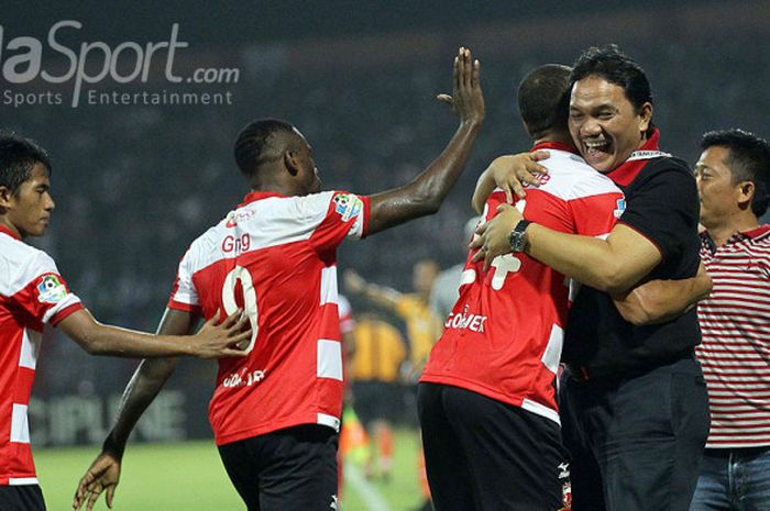 Presiden Madura United, Achsanul Qosasi (kanan), memeluk striker Peter Odemwingie, usai mencetak gol ke gawang Persib dalam laga pekan ke-13 Gojek Traveloka Liga 1 di Stadion Gelora Ratu Pamellingan, Jawa Timur, Minggu (09/07/2017) malam.