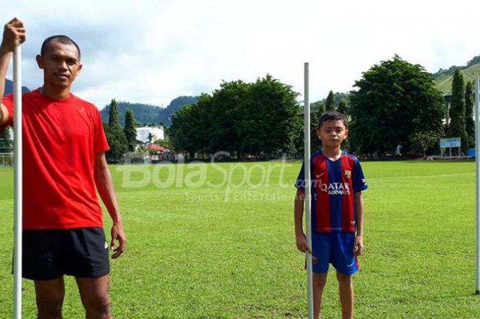 Ricardo Salampessy dan putranya, Reno, di Lapangan PLTA Waena, Jayapura, Papua, Kamis (14/12/2017).