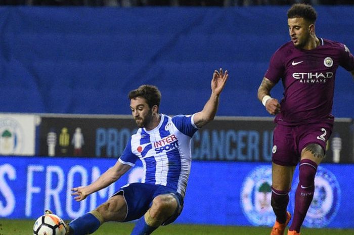 Penyerang Wigan Athletic, Will Grigg (kiri), mencetak gol ke gawang Manchester City dalam laga babak kelima Piala FA di Stadion DW, Wigan, Inggris, pada 19 Februari 2018.