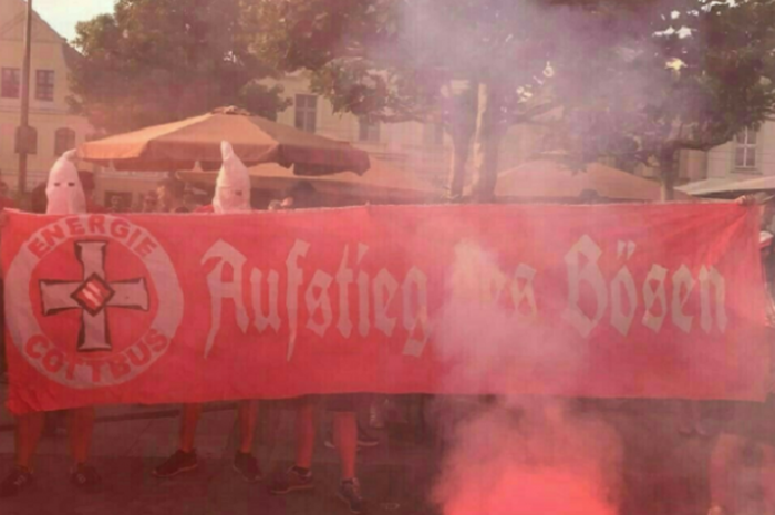 Penggemar FC Energie Cottbus, menggunakan atribut terlarang Ku Klux Klan dalam perayaan promosi timnya ke tingkat tiga Bundesliga. 