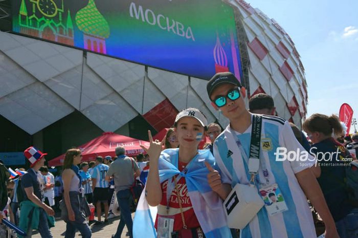 Wang Yiyi (kiri) dan Wang Bowen (kanan), sepasang kekasih dari China yang datang ke Rusia untuk mendukung Argentina melawan Islandia di Spartak Stadium, Sabtu (16/6/2018) malam WIB.