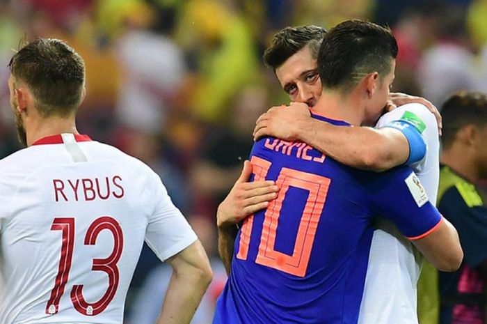 Penyerang Polandia, Robert Lewandowski (kanan), memeluk gelandang Kolombia, James Rodriguez, seusai laga Grup H Piala Dunia 2018 di Kazan Arena, Kazan, Rusia pada 24 Juni 2018.