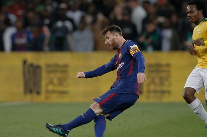 Megabintang FC Barcelona, Lionel Messi (kiri), melepaskan tendangan dalam laga perayaan ulang tahun ke-100 Nelson Mandela kontra Mamelodi Sundowns di Stadion FNB Soccer, Durban, Afrika Selatan pada 16 Mei 2018.