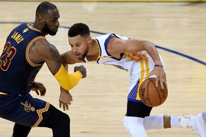 Guard Golden State Warriors, Stephen Curry (jersey putih, #30), mendapat penjagaan ketat dari forward Cleveland Cavaliers, LeBron James (#23), pada gim kesatu final NBA di Oracle Arena, Oakland, California, Kamis (1/6/2017) malam waktu setempat. Warriors menang dengan skor 113-91.