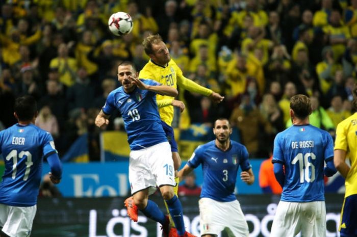 Striker Swedia, Ola Toivonen (atas), berduel dengan bek Italia, Leonardo Bonucci, dalam laga play off Kualifikasi Piala Dunia 2018 Zona Eropa di Solna, Swedia, pada 10 November 2017.