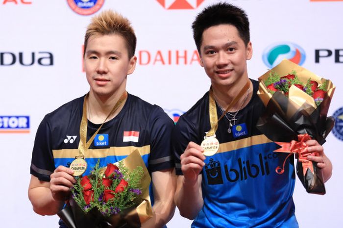 Marcus Fernaldi Gideon/Kevin Sanjaya Sukamuljo saat berpose bersama seusai berhasil menjuarai ajang MAlaysia Masters 2019 yang tuntas diselenggarkan pada Minggu (20/1/2019).