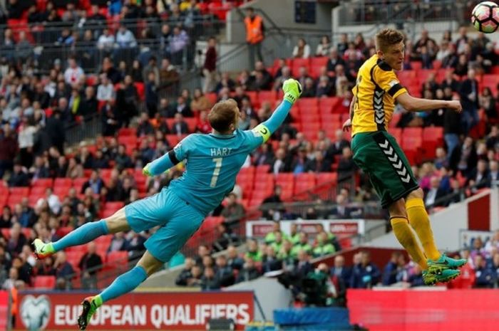 Kiper Inggris, Joe Hart, berduel dengan gelandang Lithuania, Vykintas Slivka (kanan), dalam laga Grup F Kualifikasi Piala Dunia 2018 zona Eropa di Stadion Wembley, London, Inggris, pada 26 Maret 2017. 