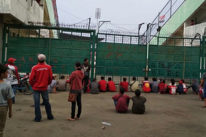 Sebagian Pasoepati terlihat menikmati laga dari celah gerbang stadion manahan pada laga antara Persis Solo vs PSS Sleman