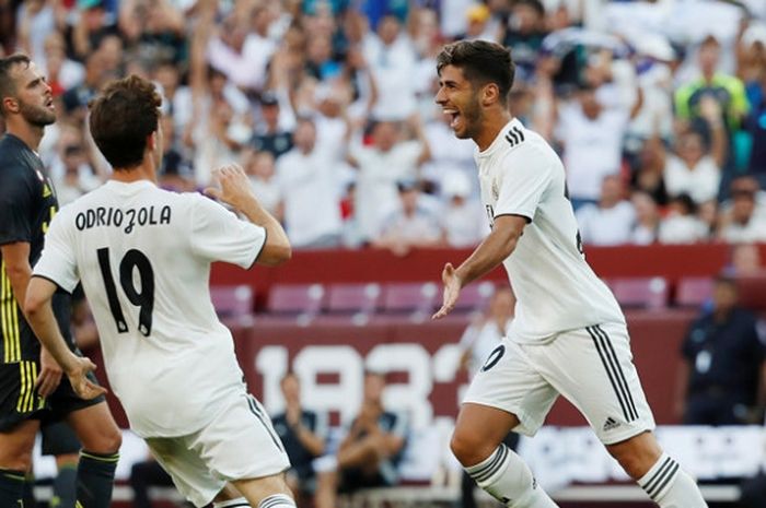  Pemain Real Madrid, Marco Asensio, melakukan selebrasi seusai menjebol gawang Juventus dalam laga di FedEx Field, Sabtu (4/8/2018) 