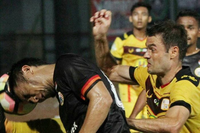 pemain Persija duel dengan pemain Barito Putera