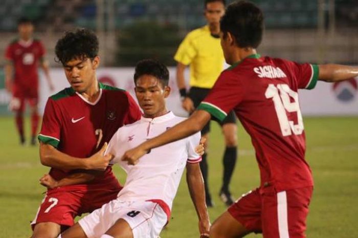 Duo pemain timnas U-19 Indonesia, Muhamad Luthfi Kamal Baharsyah (kiri) dan Hanis Saghara Putra mengapit pilar timnas U-19 Myanmar, Myat Kaung Khant pada laga pertama Grup B Piala AFF U-18 edisi 2017 di Stadion Thuwunna, Yangon, Selasa (5/9/2017) malam. 