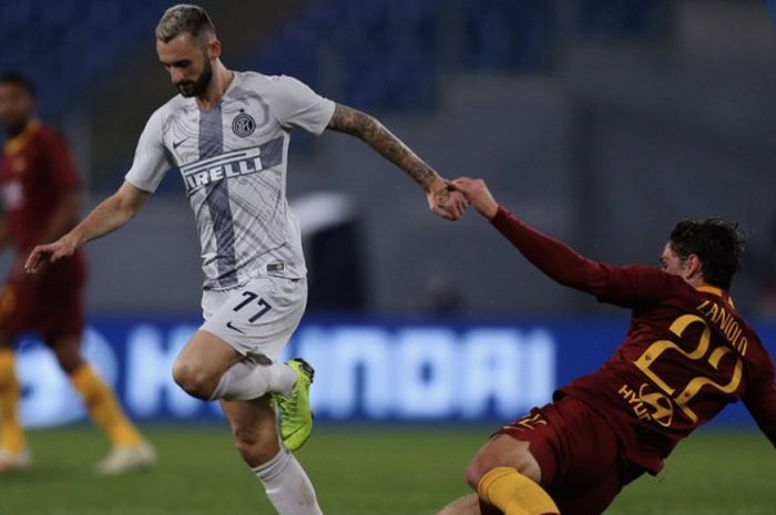 Gelandang Inter Milan, Marcelo Brozovic, menghindari tekel pemain AS Roma, Nicolo Zaniolo dalam laga pekan ke-14 Liga Italia di Stadion Olimpico, Roma, Senin (3/12/2018) dini hari WIB.