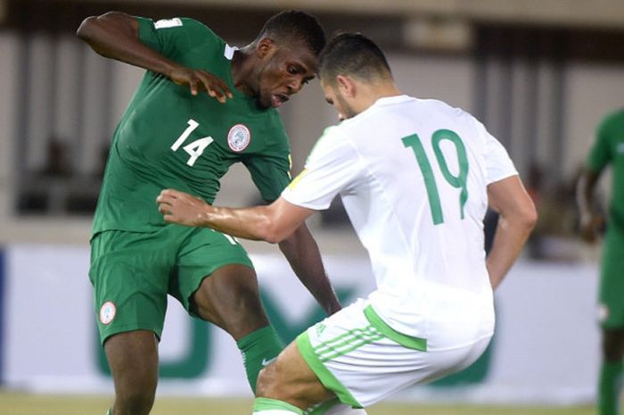 Penyerang timnas Nigeria, Kelechi Iheanacho (kiri), berduel dengan gelandang Aljazair, Mehdi Abeid, dalam partai kualifikasi Piala Dunia 2018 zona Afrika di Akwa Ibom State, 12 November 2016.