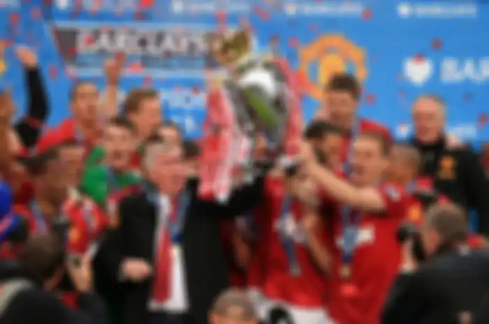 Manchester United manager Sir Alex Ferguson celebrates with the Premier League trophy