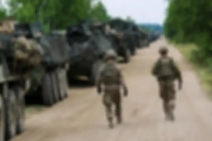 Dua tentara Amerika di samping jejeran AFV Stryker 
