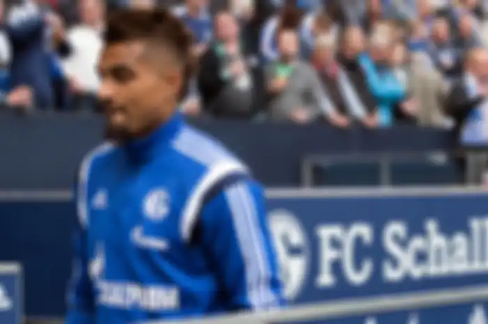 Schalke's Kevin-Prince Boateng takes his seat on the bench prior to the German Bundesliga soccer mat