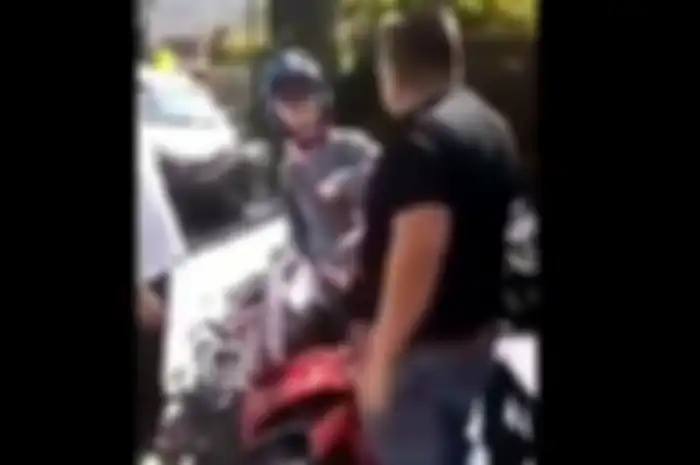 Pria berbadan kekar terlihat sedang memarahi pemotor wanita yang menabrak dan memukul-mukul mobilnya