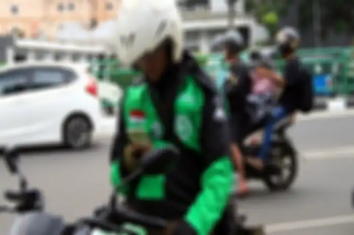 Ilustrasi driver ojol. Aturan PSBB Jakarta bikin driver ojol merana.