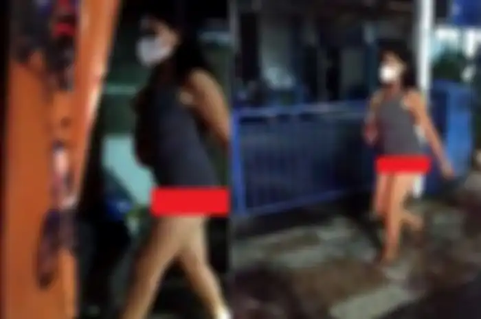 Seorang wanita bermasker yang berjalan tanpa mengenakan celana