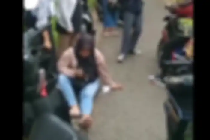Wanita terduduk lemas usai motor Yamaha NMAXnya dirampas begal.
