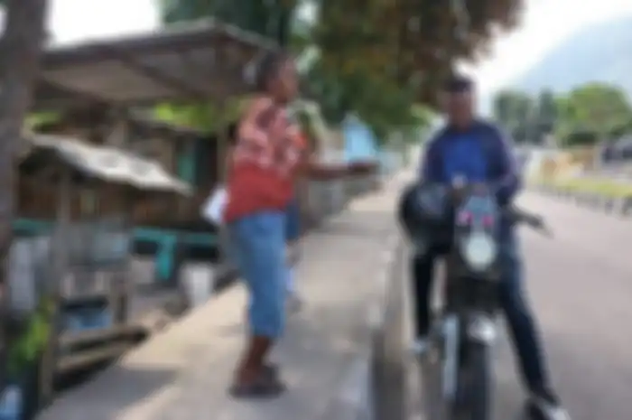 Oma Maria Bai, penjual Pertalite di Ende saat melayani pembeli.