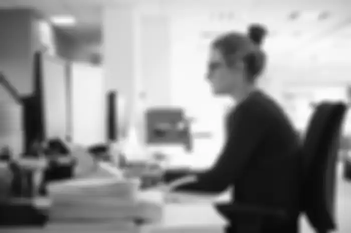 Young woman using computer in office