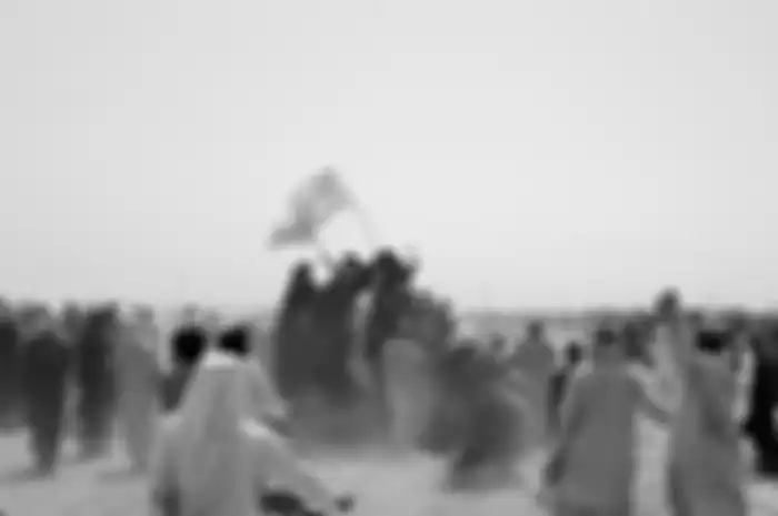 People standing on a vehicle hold Taliban flags as people gather near the Friendship Gate crossing point in the Pakistan-Afghanistan border town of Chaman, Pakistan July 14, 2021. Picture taken July 14, 2021. REUTERS/Abdul Khaliq Achakzai