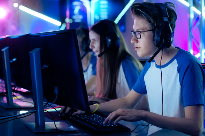 Team of Professional Cybersport Gamers Playing Video Games on a Cyber Games Tournament. Girls and Bo