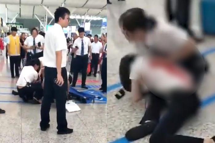 Wanita China menusuk staf stasiun.