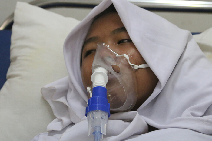 Salah seorang siswa Sekolah Tsanawiyah Negeri (MTsN) 1 Aceh Barat yang berada di Desa Blang Bale, Kecamatan Samatiga, mendapat penanganan medis, Selasa (30/7/2019). Sebanyak lima siswa MTsN 1 Aceh Barat mengalami pingsan dan sesak napas akibat kabut asap kebakaran hutan dan lahan gambut.
