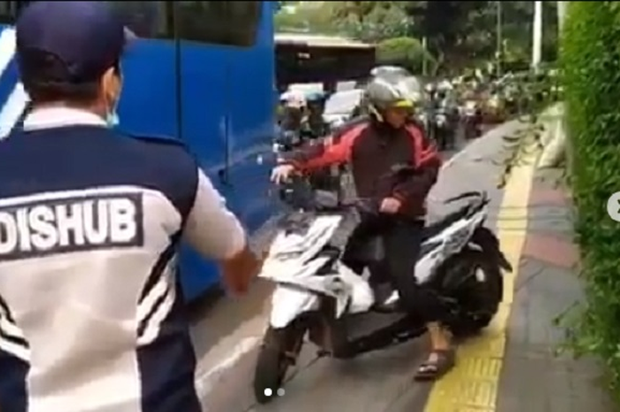 Petugas Dishub DKI Jakarta menghalau pemotor yang lewat trotoar