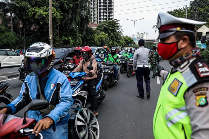 Petugas gabungan dari TNI, Polri, Polisi Pamong Praja dan Dishub DKI Jakarta melakukan imbauan kepada pengendara mobil dan motor untuk dapat mematuhi penerapan Pembatasan Sosial Berskala Besar (PSBB) di jalan Penjernihan, Tanah Abang, Jakarta Pusat, Senin (13/4/2020).