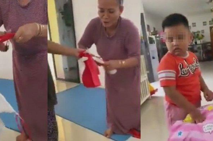 Seorang ibu potong bendera merah putih di hadapan anak-anak