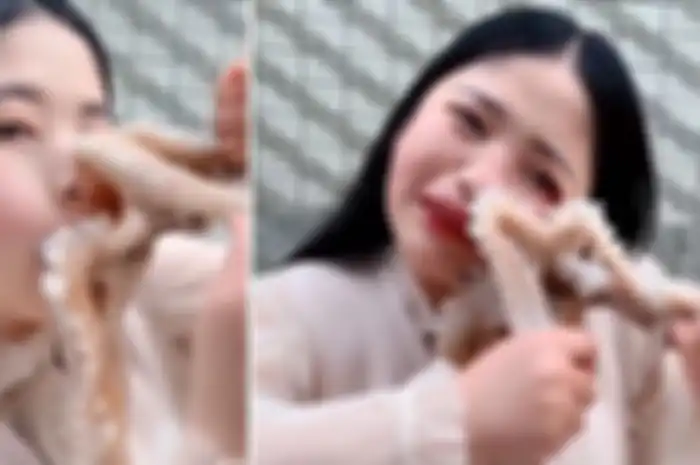 Gadis ditempeli gurita yang akan dia makan.